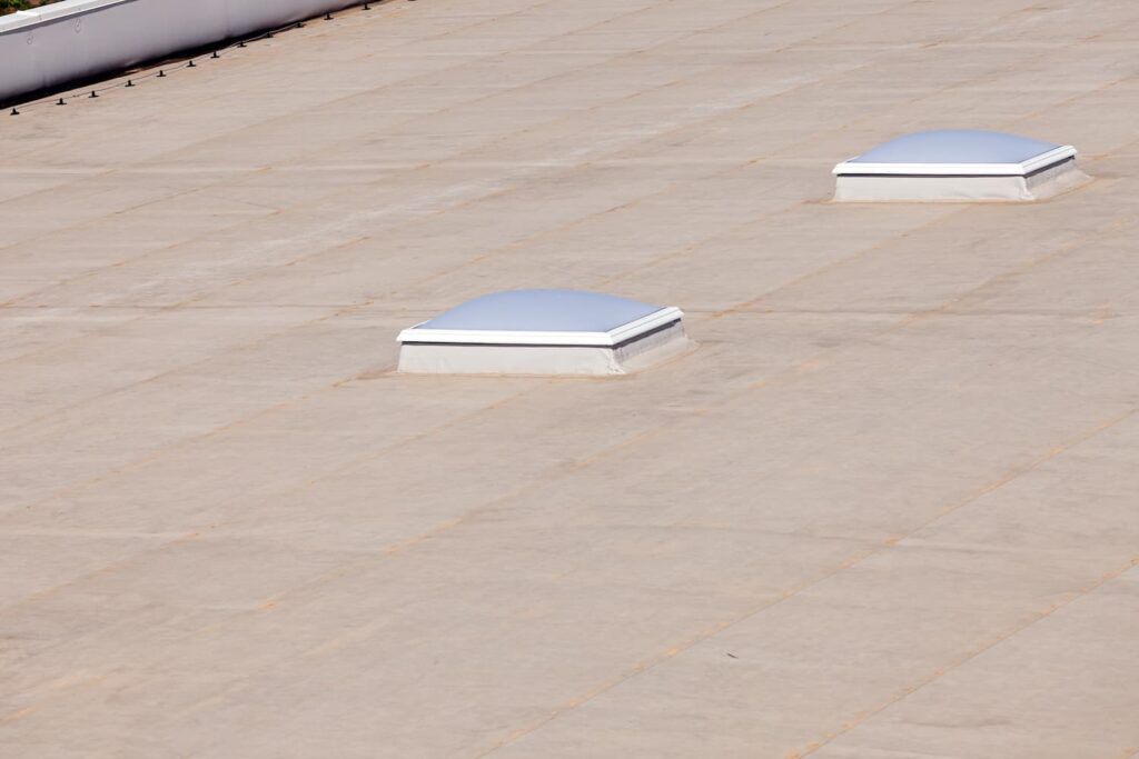 Two white domed structures on a flat roof